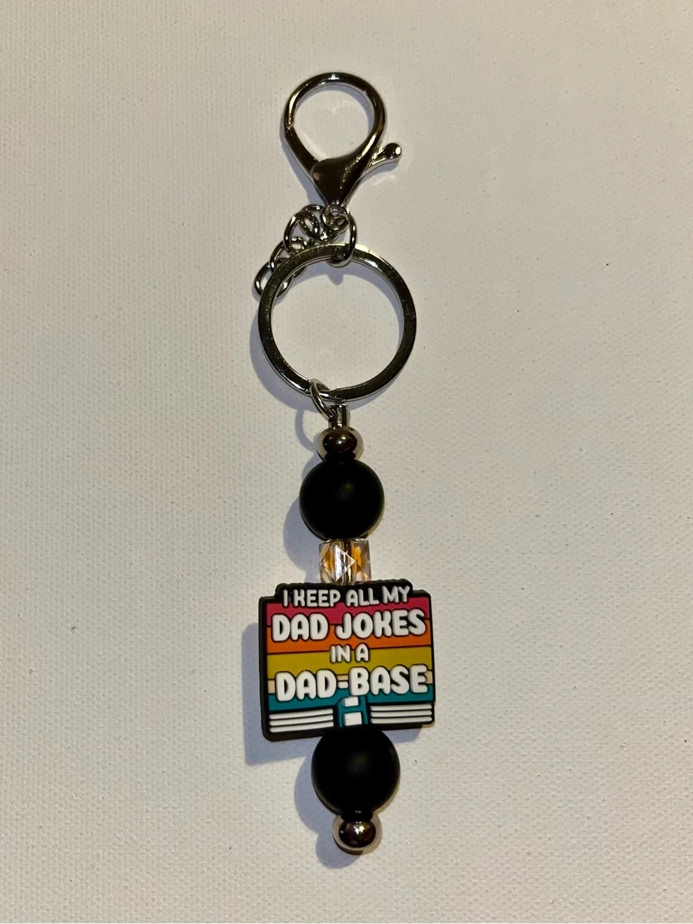 ‘I Keep All My Jokes in a Dad-Base’ Black with Retro Stripes Keychain